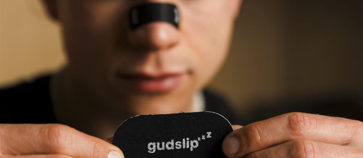 Person sleeping peacefully at night, representing nasal breathing and mouth tape
