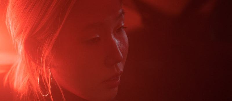 Woman illuminated by red light