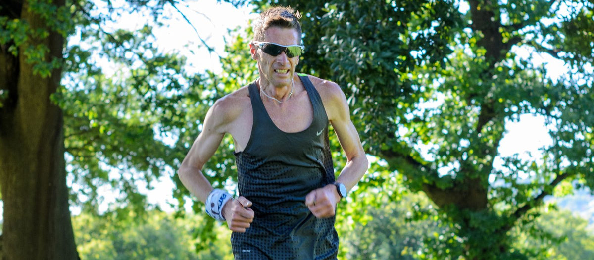 Man running along a forest trail in sportswear