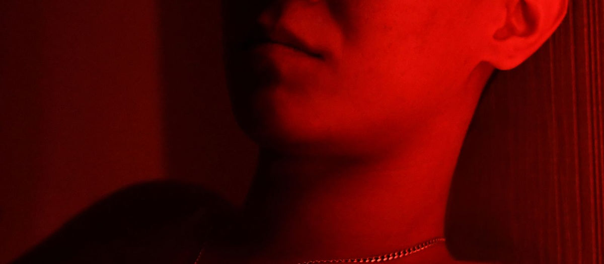 Man relaxing with eyes closed in red light