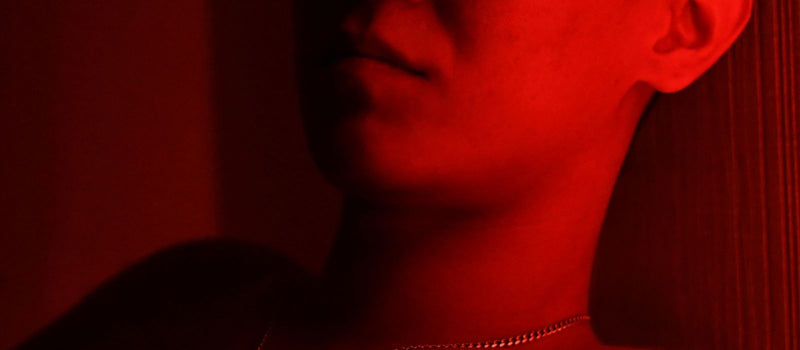 Man relaxing with eyes closed in red light