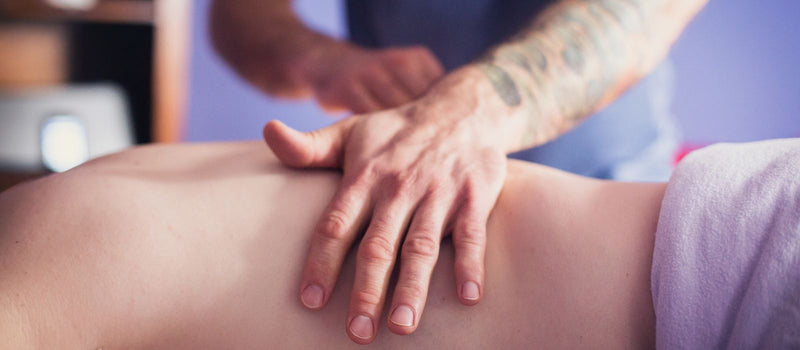 Hands applying pressure during a relaxing back massage