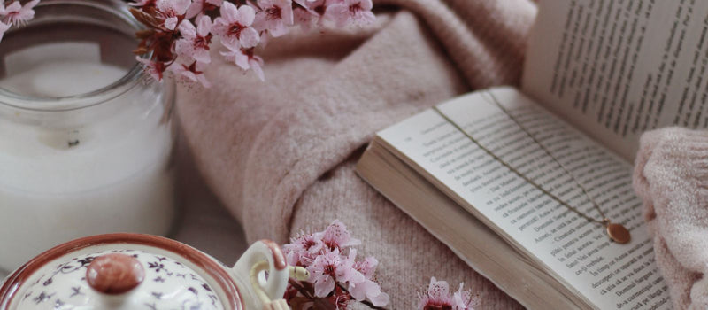 Cup of herbal tea and a book in a cozy room before bed