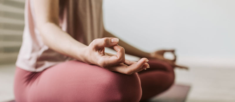 Woman meditating calmly to unwind