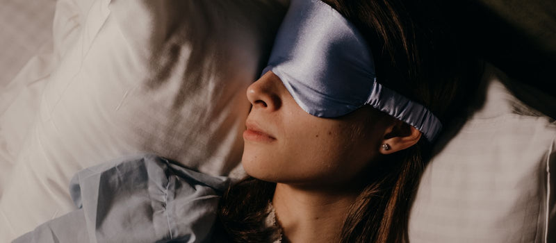 Woman sleeping with a silk eye mask